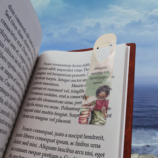 Open book with a bookmark featuring a person reading, against a scenic background of water and sky.