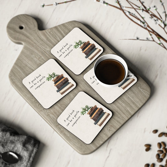 Set of four coasters with book-themed designs on a wooden board with a cup of coffee. Book Lover Coaster Coffee Lover Set