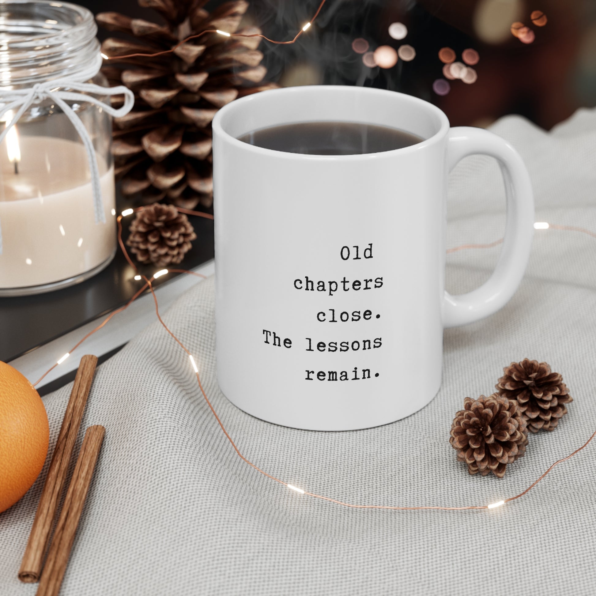 White mug with a quote on a table with decorative items