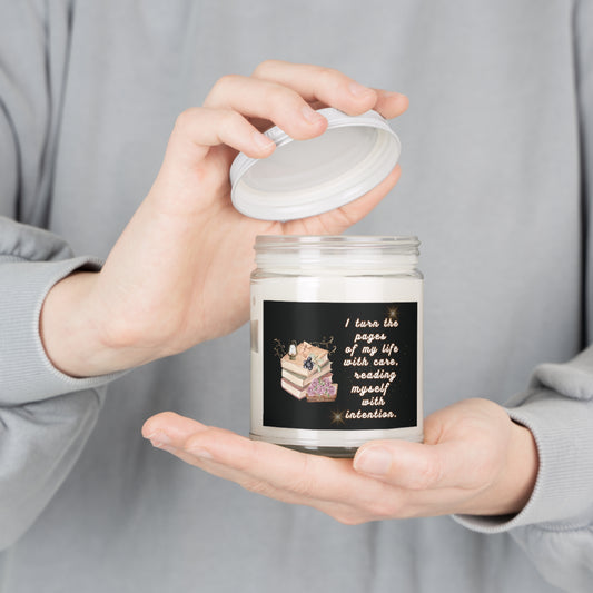Person holding a candle jar with a decorative label against a neutral background