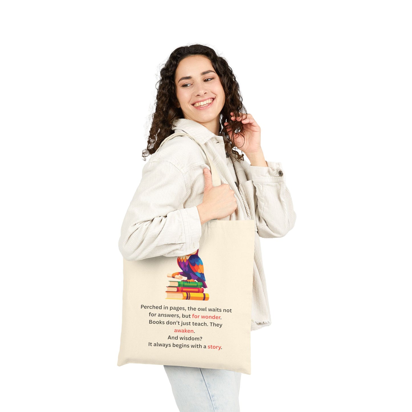 Woman holding a tote bag with a colorful owl design and text.