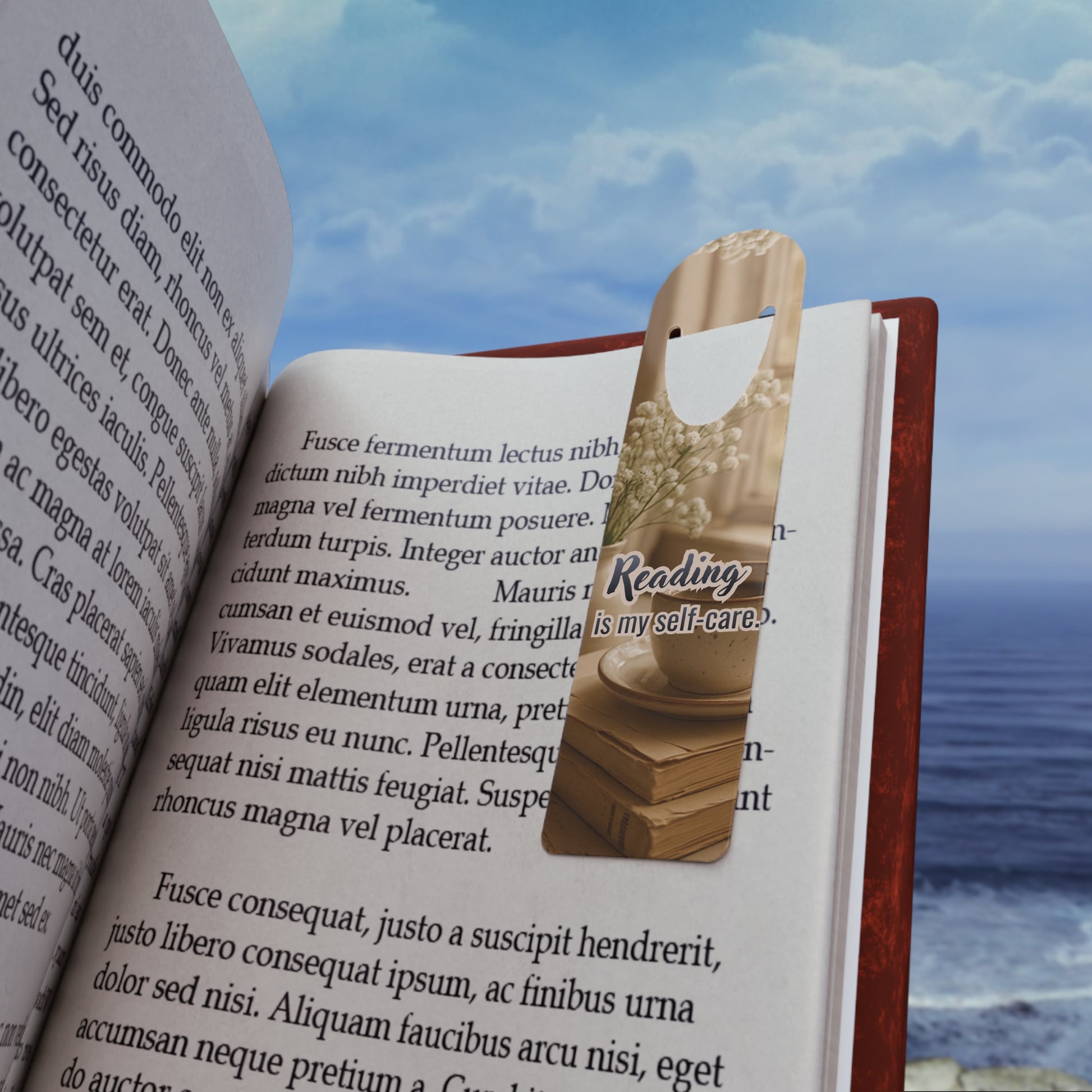 metal aluminum bookmark with 'Reading is my self-care' text on an open book with a scenic background.