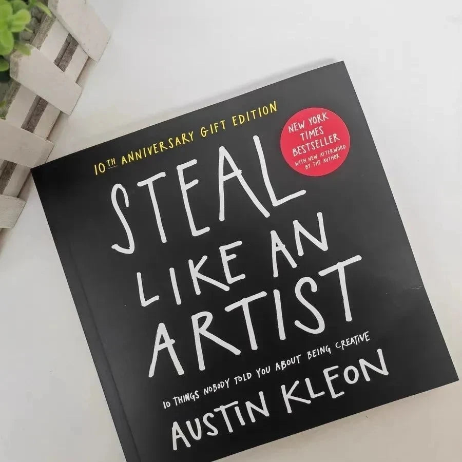 Book titled 'Steal Like an Artist' by Austin Kleon on a white surface