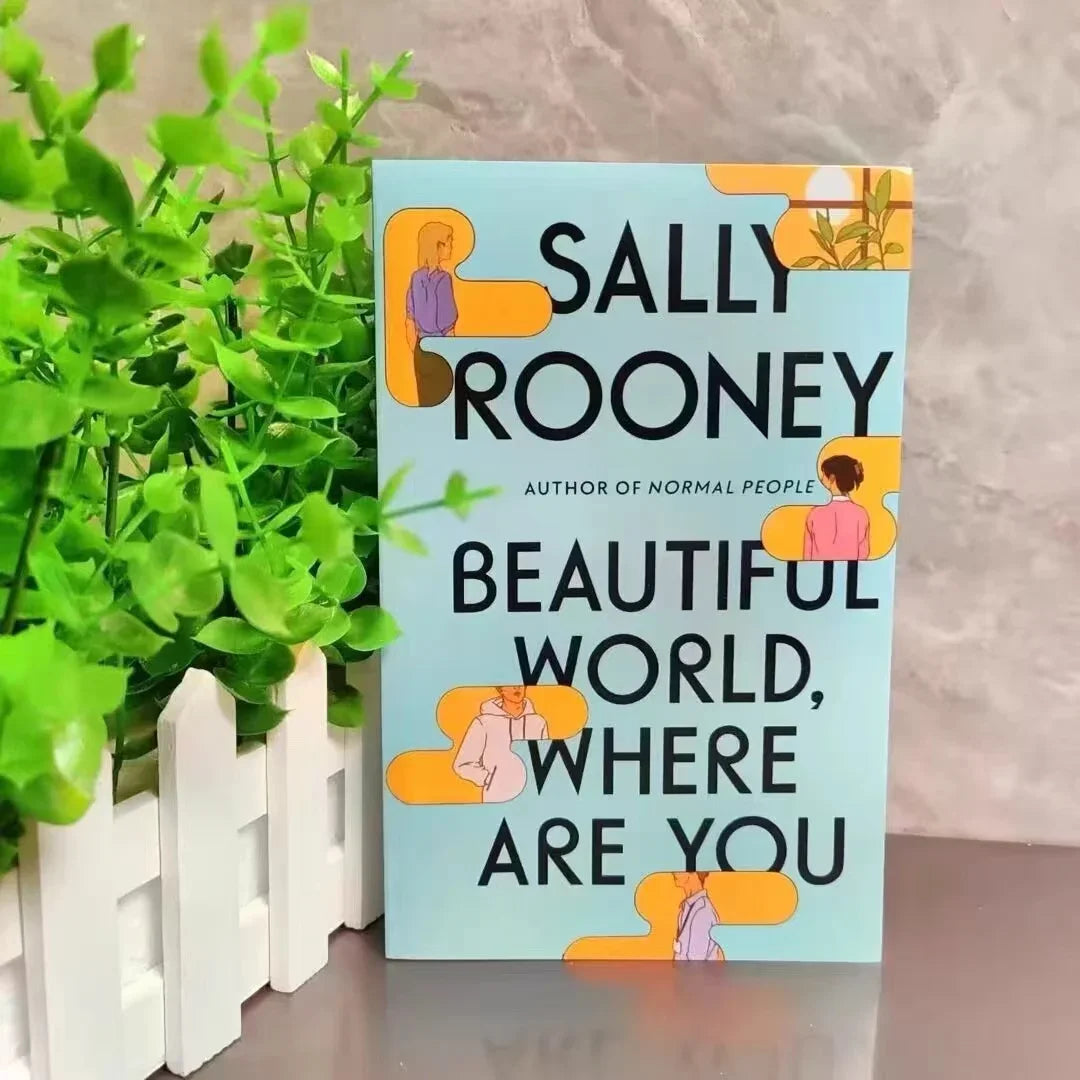 Book titled 'Beautiful World, Where Are You' by Sally Rooney with a plant in the background