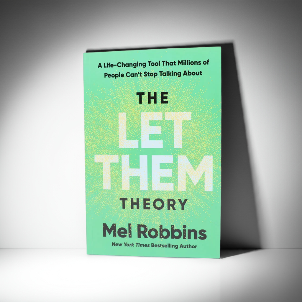 Book titled 'The Let Them Theory' by Mel Robbins on a white surface with decorative elements.